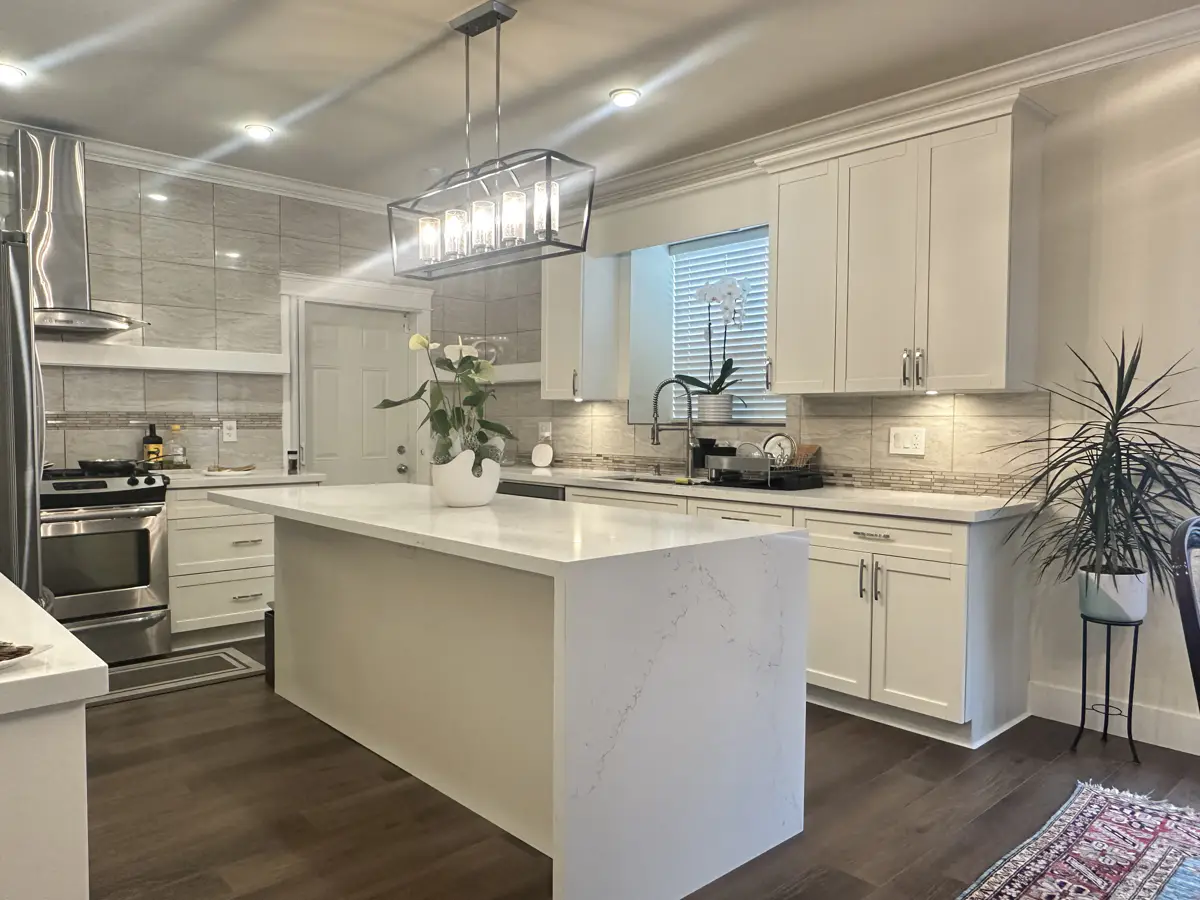 White shaker kitchen with waterfall quartz island and pendant lighting, Langley home renovation