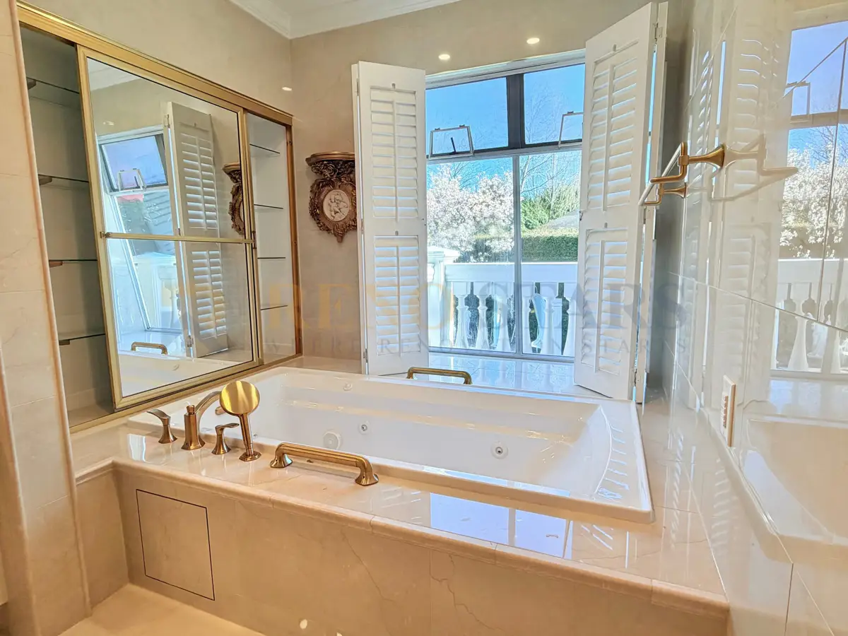 Freestanding bathtub with champagne gold fixture in a West Vancouver luxury bathroom renovation