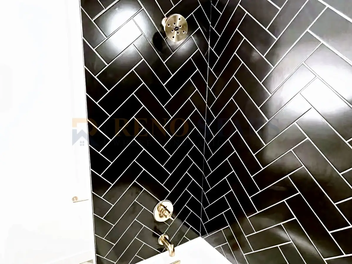North Vancouver bathroom renovation with black herringbone tile, frameless glass shower, and floating vanity