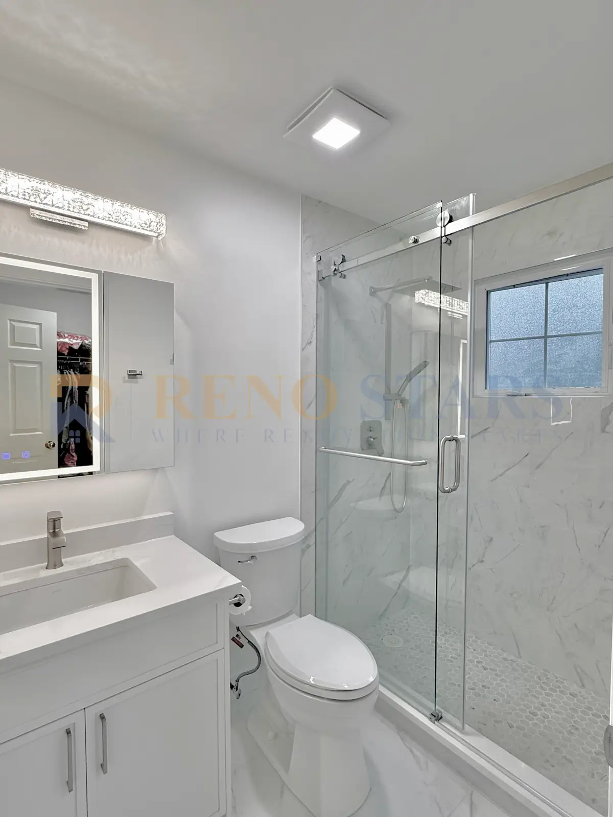 Two-bathroom renovation in Burnaby with brushed gold fixtures and modern tile
