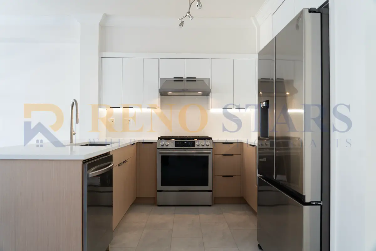 Minimalist white kitchen with shaker cabinets, quartz countertops, and open layout in Richmond BC
