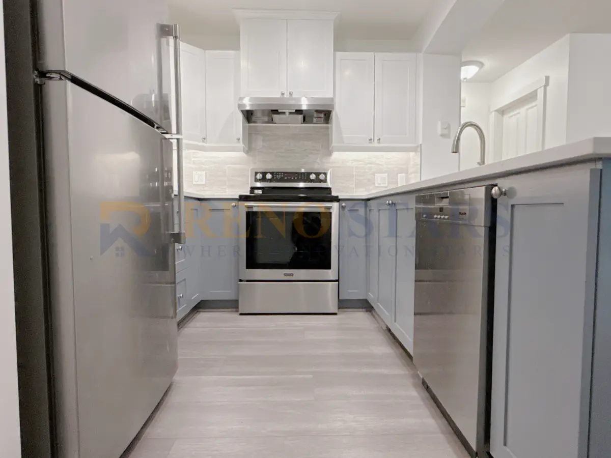 Kitchen renovation in Coquitlam with bright white cabinets and modern pendant lighting