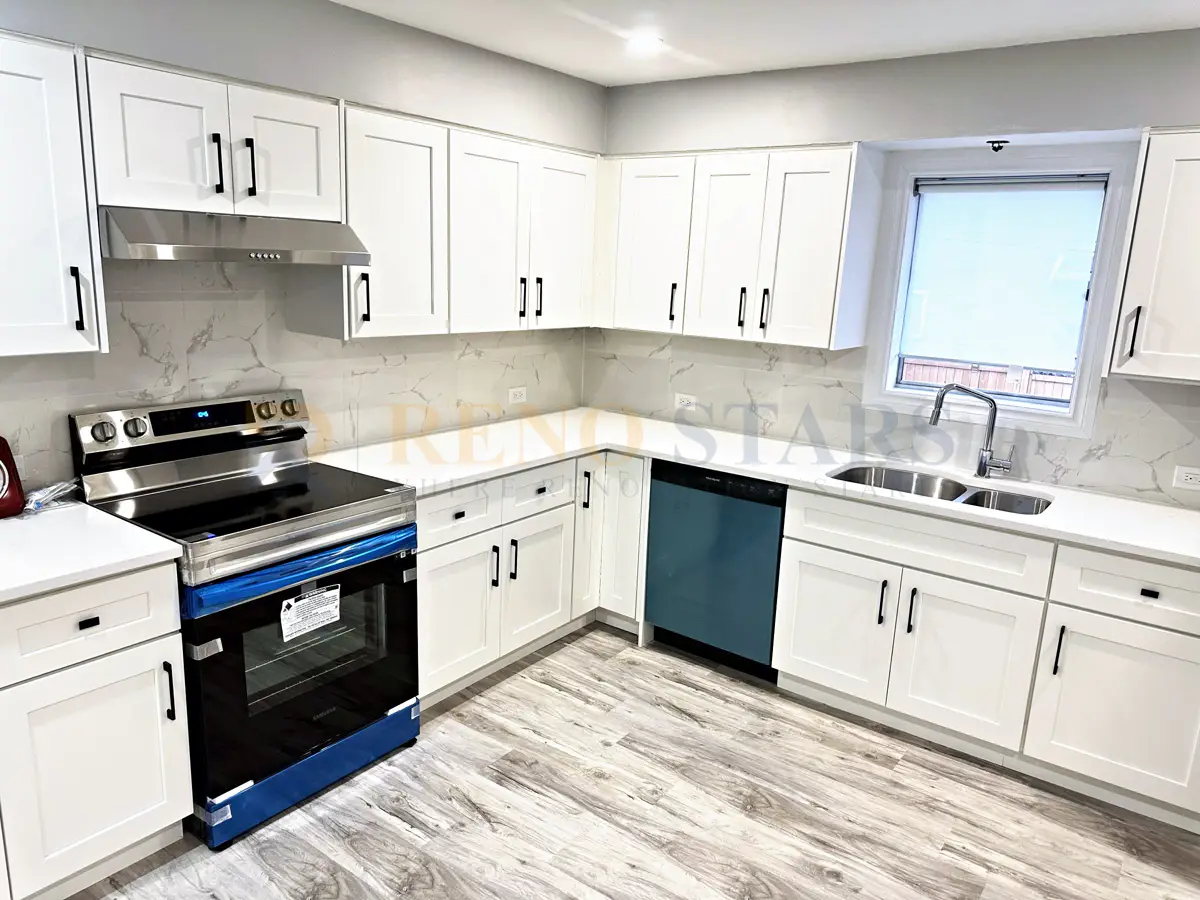 Completed kitchen renovation in Vancouver with white shaker cabinets, quartz countertops, and open shelving